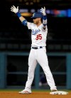 Los Angeles Dodgers' Cody Bellinger raises his arms in celebration after driving in a run with a double against the New York Mets during the ninth inning of a baseball game Wednesday, May 29, 2019, in Los Angeles. (AP Photo/Marcio Jose Sanchez)