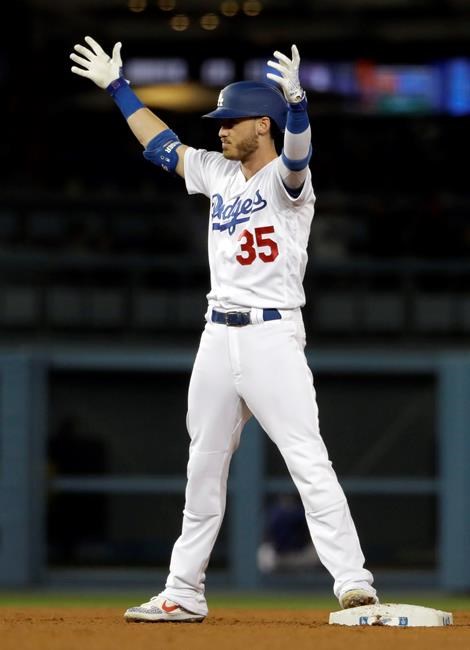 Los Angeles Dodgers' Cody Bellinger raises his arms in celebration after driving in a run with a double against the New York Mets during the ninth inning of a baseball game Wednesday, May 29, 2019, in Los Angeles. (AP Photo/Marcio Jose Sanchez)
