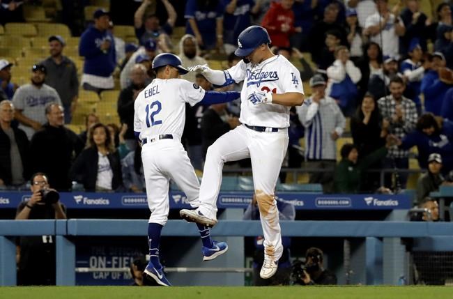 Los Angeles Dodgers' Joc Pederson, right, celebrates with third base coach Dino Ebel (12) after hitting a solo home run during the ninth inning of a baseball game against the New York Mets Wednesday, May 29, 2019, in Los Angeles. (AP Photo/Marcio Jose Sanchez)
