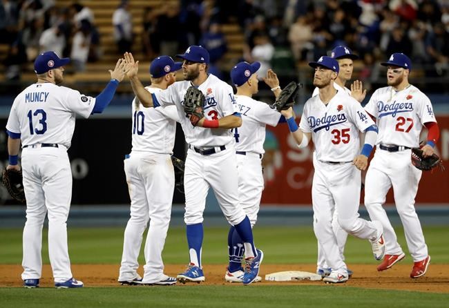 The Los Angeles Dodgers celebrate after a 9-5 win over the New York Mets in a baseball game, Monday, May 27, 2019, in Los Angeles. (AP Photo/Marcio Jose Sanchez)