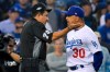 Los Angeles Dodgers manager Dave Roberts talks with home plate umpire Alfonso Marquez after the second inning in Game 5 of the baseball team's National League Division Series against the Washington Nationals on Wednesday, Oct. 9, 2019, in Los Angeles. (AP Photo/Mark J. Terrill)