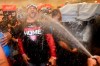 Washington Nationals manager Dave Martinez celebrates in the locker room after the Nationals' 7-3 win in 10 innings against the Los Angeles Dodgers in Game 5 of a baseball National League Division Series on Wednesday, Oct. 9, 2019, in Los Angeles. (AP Photo/Marcio Jose Sanchez)