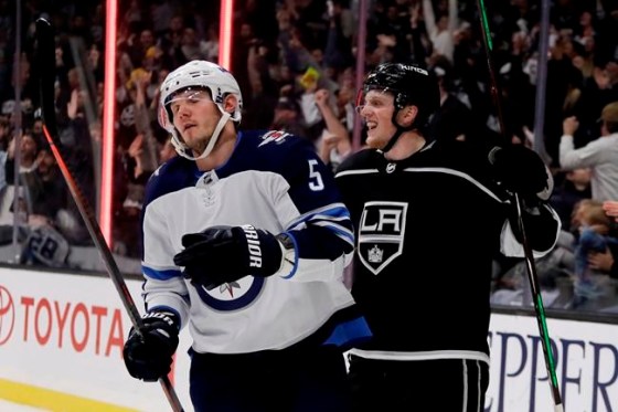 Los Angeles Kings left wing Austin Wagner, right, celebrates after scoring as Winnipeg Jets defenseman Dmitry Kulikov reacts during the second period of an NHL hockey game in Los Angeles, Tuesday, Dec. 18, 2018. (AP Photo/Chris Carlson)