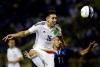 FILE - In this Friday, Sept. 2, 2016 file photo, Mexico's Hector Herrera, left, fights for the ball with El Salvador's Nelson Bonilla during a 2018 World Cup qualifier soccer match in San Salvador, El Salvador. Atletico Madrid says it has reached a deal to sign Mexico midfielder Héctor Herrera and the 29-year-old player will sign a three-year contract on Thursday July 4, 2019. (AP Photo/Salvador Melendez, File)