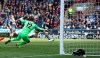 Leicester City's Jamie Vardy, right, scores against Huddersfield Town during the English Premier League soccer match at the John Smith's Stadium, Huddersfield, England, Saturday April 6, 2019. (Martin Rickett/PA via AP)