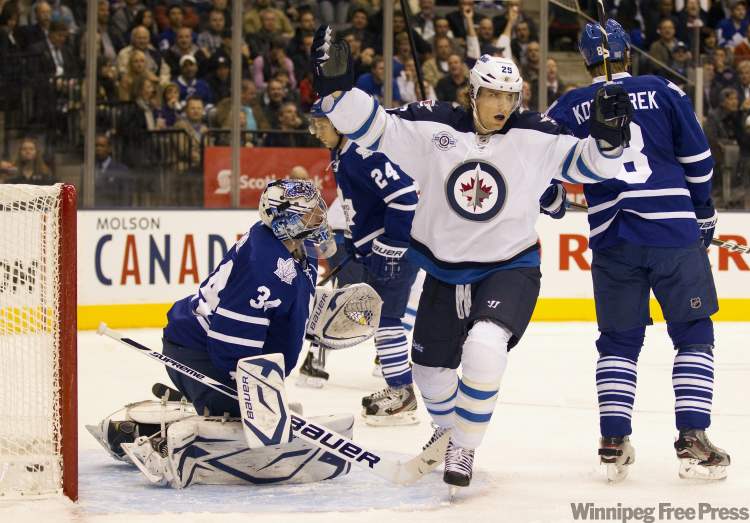 Frank Gunn / The Canadian Press
Toronto Maple Leafs goaltender James Reimer and defenceman Mike Komisarek (right) react as Winnipeg Jets left winger Brett MacLean (25) celebrates a goal by teammate Tobias Enstrom, not shown, during first period action in Toronto on Wednesday.
