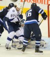 Phil Hossack / Winnipeg Free Press
Tampa Bay Lightning netminder Mathieu Garon peers through traffic at the puck while Matt Gilroy (97) and Winnipeg Jet Captain Andrew Ladd battle for possession in the first period at the MTS Centre Thursday.