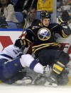 Gary Wiepert / Associated Press archives
Tampa Bay Lightning Ryan Malone gets checked into the boards by Buffalo Sabres Adam Pardy during the second period of a game in Buffalo.