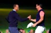 Tiger Woods of the United States, left, and Jason Day of Australia, right, hold their hands on the 18th hole after the Challenge: Japan Skins event ahead of the Zozo Championship PGA Tour at Accordia Golf Narashino C.C. in Inzai, east of Tokyo, Monday, Oct. 21, 2019. (AP Photo/Lee Jin-man)