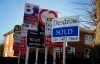 Estate Agent boards stand outside properties in London, Friday, Jan. 4, 2019. A raft of economic figures released Friday showed the British economy weakening at the turn of the year just as Prime Minister Theresa May delayed a parliamentary vote on the Brexit deal she agreed on with the EU. House prices are down and business optimism in the key services sector is at its second-weakest level since the global financial crisis a decade ago. (AP Photo/Kirsty Wigglesworth)