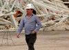 FILE - In this Monday, Dec. 2, 2013 file photo, Former Corinthians president Andres Sanchez walks past the damage caused by the collapse at the Corinthians Arena stadium that will host the opening match of the World Cup, in Sao Paulo, Brazil. Two months before the opening of Copa America in Brazil, Sao Paulo‚Äôs Arena Corinthians stadium, which hosts three important matche,s is fighting a fungus infection. The stadium will close later this month so the change can be made in time for the start of the tournament on June 14, 2019. Corinthians President Andres Sanchez said the stadium will close after the Sao Paulo state championship final on April 21. The installation will take one month and Corinthians will not play there again until the Copa America has ended, he said. (AP Photo/Andre Penner, file)