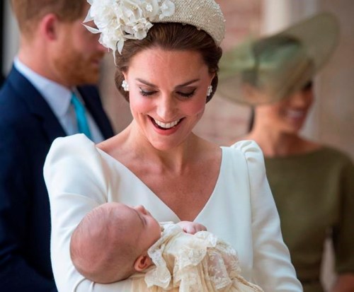 FILE - In this Monday, July 9, 2018 file photo, Kate, Duchess of Cambridge carries Prince Louis as they arrive for his christening service at the Chapel Royal, St James's Palace, London. The youngest child of Prince William and his wife Kate is about to celebrate his first birthday. Prince Louis will mark the milestone Tuesday, April 23, 2019. (Dominic Lipinski/Pool Photo via AP, file)