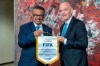 FIFA President Gianni Infantino, right, and Tedros Adhanom Ghebreyesus, left, Director General of the World Health Organization (WHO), pose for the media at the World Health Organization (WHO) headquarters in Geneva, Switzerland, Friday, Oct. 4, 2019. FIFA president Gianni Infantino says a new partnership with the U.N. health agency is a 