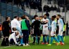 The referee speaks to players as the match is suspended during a French League One soccer match between Olympique Marseille and Lille at the Stade Velodrome in Marseille, France, Friday, Jan. 25, 2019. (AP Photo/Claude Paris)