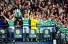 Celtic's Scott Brown, left, and Mikael Lustig celebrate with the trophy after winning the Scottish Cup Final at Hampden Park, Glasgow, Scotland, Saturday, May 25, 2019. Celtic wrapped up a domestic treble for an unprecedented third straight season after beating Hearts 2-1 in the Scottish Cup Final on Saturday. Having already won the Scottish League Cup and league titles, Celtic rallied at Hampden Park with a brace from striker Odsonne Edouard. (Jeff Holmes/PA via AP)