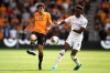 Wolverhampton Wanderers' Jesus Vallejo, left, and Chelsea's Tammy Abraham battle for the ball during their English Premier League soccer match at Molineux, Wolverhampton, England, Saturday, Sept. 14, 2019. (Nick Potts/PA via AP)