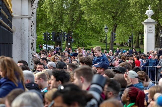 Well wishers gather outside the gates of Buckingham Palace in London, Monday May 6, 2019, after Prince Harry announced that his wife Meghan, Duchess of Sussex, has given birth to a boy. (AP Photo/Vudi Xhymshiti)