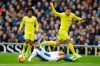Chelsea's Eden Hazard, right, challenged by Brighton's Martin Montoya, bottom, passes the ball to Chelsea's Pedro during the English Premier League soccer match between Brighton and Hove Albion and Chelsea at the Amex Stadium in Brighton, England, Sunday, Dec. 16, 2018. (AP Photo/Matt Dunham)