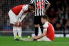 Arsenal's Aaron Ramsey sits injured with Arsenal's Alexandre Lacazette, left, before leaving the game during the English Premier League soccer match between Arsenal and Newcastle United at Emirates stadium in London, Monday, April 1, 2019. (AP Photo/Kirsty Wigglesworth)