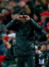 Liverpool head coach Juergen Klopp holds his cap during the Champions League round of 16 first leg soccer match between Liverpool and Bayern Munich at Anfield stadium in Liverpool, England, Tuesday, Feb. 19, 2019. (AP Photo/Dave Thompson)