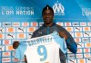 FILE - In this file photo dated Wednesday, Jan. 23, 2019, Olympique Marseille's new player Mario Balotelli poses during a press conference, at the club's headquarters of La Commanderie, in Marseille, southern France. The French club Marseille, is out of European competition after a fifth-place finish in Ligue 1, despite an attack that includes Mario Balotelli, and now Marseille must pay UEFA 2 million euros ($2.24 million) for breaking financial fair play rules, according to a UEFA announcement Wednesday June 19, 2019. (AP Photo/Claude Paris, FILE )