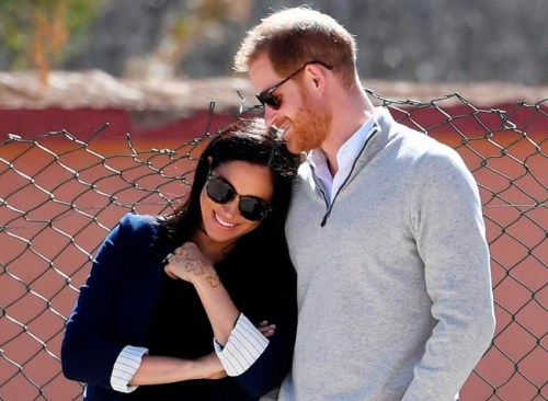 FILE - In this Sunday, Feb. 24, 2019 file photo, Britain's Prince Harry and Meghan, Duchess of Sussex, watch children playing football at a school in the town of Asni, in the Atlas mountains, Morocco. The time is drawing near for the impending royal birth of the first child for Prince Harry and his wife Meghan, the Duchess of Sussex. The couple is keeping many details about Meghan‚Äôs pregnancy and birth plan private and say they don‚Äôt know the baby‚Äôs gender yet. (Facundo Arrizabalaga/Pool via AP, File)