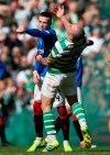 Rangers' Ryan Kent, left, and Celtic's Scott Brown clash during their Scottish Premiership soccer match at Celtic Park in Glasgow, Scotland, Sunday March 31, 2019. (Andrew Milligan/PA via AP)