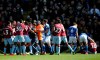 A fan is removed after attacking Aston Villa's Jack Grealish, right, on the pitch during the Sky Bet Championship soccer match at St Andrew's Trillion Trophy Stadium, Birmingham, England, Sunday March 10, 2019. (Nick Potts/PA via AP)