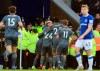 Leicester City's Jamie Vardy looks out as he is mobbed by team-mates after scoring his sides first goal of the game against Everton, during their English Premier League soccer match at Goodison Park in Liverpool, England, Tuesday Jan. 1, 2019. (Peter Byrne/PA via AP)