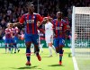 Crystal Palace's Michy Batshuayi, left, celebrates with team mate Aaron Wan-Bissaka after he scores to put his side 2-0 up during the English Premier League soccer match between Crystal Palace and Bournemouth at Selhurst Park stadium, London, England. Sunday, May 12, 2019. (Bradley Collyer/PA via AP)