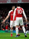 Arsenal's Henrikh Mkhitaryan, left, celebrates scoring his side's second goal of the game against Bournemouth, during their English Premier League soccer match at the Emirates Stadium in London, Wednesday Feb. 27, 2019. (Adam Davy/PA via AP)