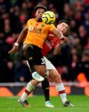 Wolverhampton Wanderers' Adama Traore, front, and Arsenal's Kieran Tierney battle for the ball during the English Premier League soccer match at The Emirates Stadium, London, Saturday Nov. 2, 2019. (Paul Harding/PA via AP)