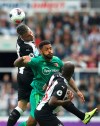 Newcastle United's Paul Dummett, left, and Watford's Adrian Mariappa battle for the ball during the English Premier League soccer match at St James' Park, London, Saturday Aug. 31, 2019. (Owen Humphreys/PA via AP)