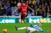 Southampton's Danny Ings, top, rides a challenge from Huddersfield Town's Florent Hadergjonaj during the English Premier League soccer match between Huddersfield Town and Southampton at the John Smith‚Äôs stadium, Huddersfield, England. Saturday, Dec. 22, 2018. (Richard Sellers/PA via AP)
