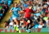 Manchester City's Georgia Stanway, left, and Manchester United's Hayley Ladd battle for the ball during the Women's Super League soccer match at the Etihad Stadium, Manchester, England, Saturday Sept. 7, 2019. (Nigel French/PA via AP)