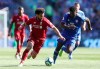Liverpool's Mohamed Salah and Cardiff City's Bruno Ecuele Manga, right, battle for the ball during the English Premier League soccer match at The Cardiff City Stadium, Cardiff, Wales, Sunday April 21, 2019. (David Davies/PA via AP)