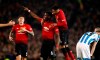 Manchester United's Paul Pogba, center, celebrates scoring against Huddersfield during the English Premier League soccer match at Old Trafford, Manchester, England, Wednesday Dec. 26, 2018. (Martin Rickett/PA via AP)
