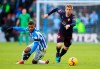 Huddersfield Town's Elias Kachunga, left, and Arsenal's Nacho Monreal in action during the English Premier League soccer match at the John Smith's Stadium in Huddersfield, England, Saturday Feb. 9, 2019. (Mike Egerton/PA via AP)