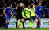 Match referee Lee Mason, center, overturns a penalty decision during the English Premier League soccer match between Cardiff City and Huddersfield Town at the Cardiff City Stadium, Cardiff, Wales. Saturday, Jan. 12, 2019. (Nick Potts/PA via AP)