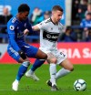 Leicester City's Demarai Gray, left, and Fulham's Joe Bryan in action during their English Premier League soccer match at the King Power Stadium in Leicester, England, Saturday March 9, 2019. (Chris Radburn/PA via AP)