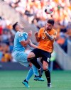 Wolverhampton Wanderers's Ruben Neves, right, and Burnley's Matthew Lowton battle for the ball during the English Premier League soccer match Between Burnley and Wolverhampton Wanderers at Molineux, Wolverhampton, England, Sunday Aug. 25, 2019. (Darren Staples/PA via AP)