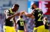 Southampton's Moussa Djenepo, left, celebrates scoring his side's opening goal with team-mate Nathan Redmond during the English Premier League soccer match between Brighton and Hove Albion and Southampton at the AMEX Arena, Brighton, England. Saturday, Aug, 24 2019 (Steven Paston/PA via AP)