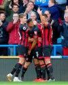 Bournemouth's Callum Wilson, centre, celebrates scoring his side's first goal of the game against Huddersfield, during their English Premier League soccer match at the John Smith's Stadium in Huddersfield, England, Saturday March 9, 2019.(Richard Sellers/ PA via AP)