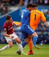 Cardiff City's Sean Morrison collides with his own team-mate goalkeeper Neil Etheridge, under pressure from West Ham United's Javier Hernandez, left, during their English Premier League soccer match at the Cardiff City Stadium, in Cardiff, Wales, Saturday March 9, 2019. (Nick Potts/PA via AP)