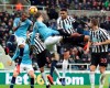 Newcastle United's Jamaal Lascelles, 2nd right, and Manchester City's John Stones, centre, in action for an aerial ball during their English Premier League soccer match at St James' Park in Newcastle, England, Tuesday Jan. 29, 2019. (Richard Sellers/PA via AP)