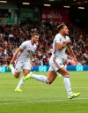 Sheffield United's Billy Sharp, right, celebrates scoring his side's first goal of the game during the English Premier League soccer match between Bournemouth and Sheffield United at the Vitality Stadium, Bournemouth, England. Saturday, Aug, 10 2019. (Mark Kerton/PA via AP)