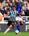 Newcastle United's Ayoze Perez, front, and Everton's Kurt Zouma, battle for the ball during their English Premier League soccer match at St James' Park in Newcastle, England, Saturday March 9, 2019. (Owen Humphreys/PA via AP)