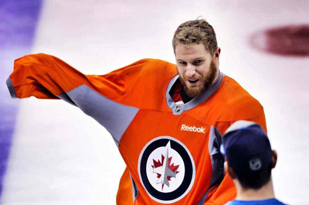 Boris Minkevich / Winnipeg Free Press
Bryan Little tugs on the orange no-contact jersey this morning at practice.