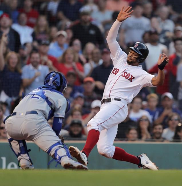 Kansas City Royals catcher Meibrys Viloria, left, sets to tag out Boston Red Sox's Xander Bogaerts, who tried to score on a double by Andrew Benintendi, during the first inning of a baseball game at Fenway Park in Boston, Monday, Aug. 5, 2019. (AP Photo/Charles Krupa)