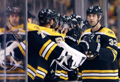 Boston Bruins defenseman Zdeno Chara, of Slovakia, is congratulated by teammates after a goal against the Washington Capitals during the third period of an NHL preseason hockey game, Monday, Sept. 23, 2013, in Boston. Chara scored twice in the Bruins' 3-2 overtime win. (AP Photo/Charles Krupa)